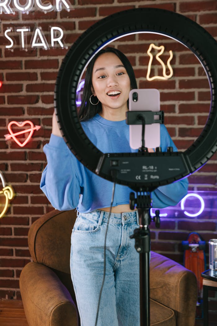 Woman creating content in trendy studio with neon lights.